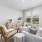 a living room with a white couch and a chair