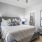 a bedroom with a bed and a fan