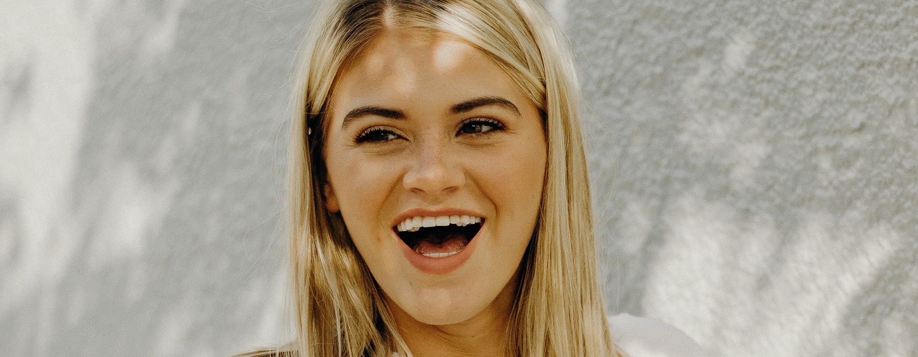 a girl laughing outdoors