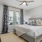 a bedroom with a bed and a fan