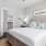 a bedroom with a bed and a mirror