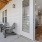 a room with a glass door and chairs